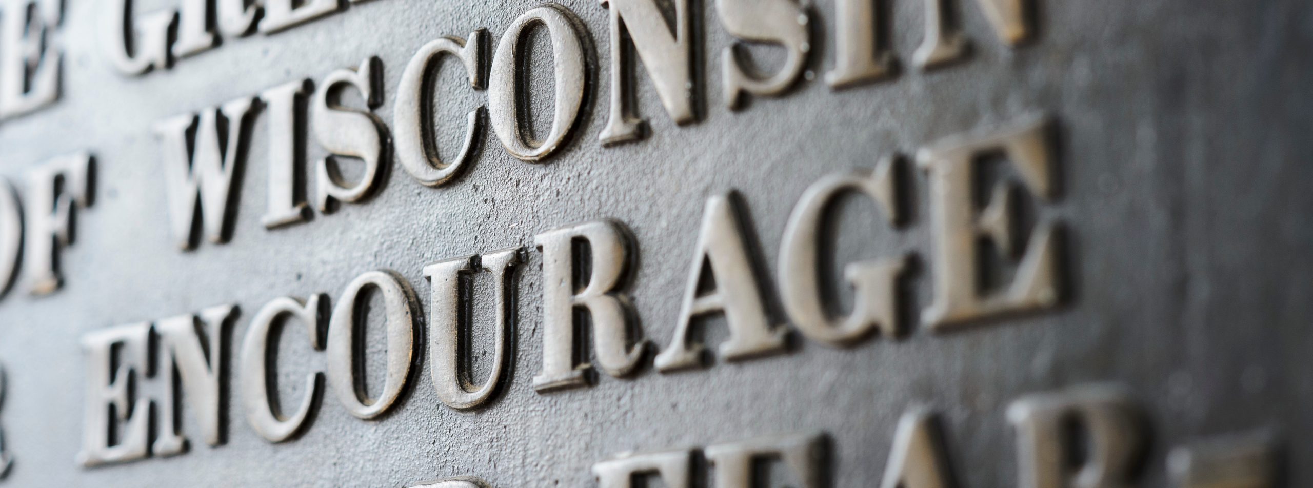 A portion of lettering on the "Sifting and Winnowing" plaque mounted in the portico of Bascom Hall at the University of Wisconsin-Madison