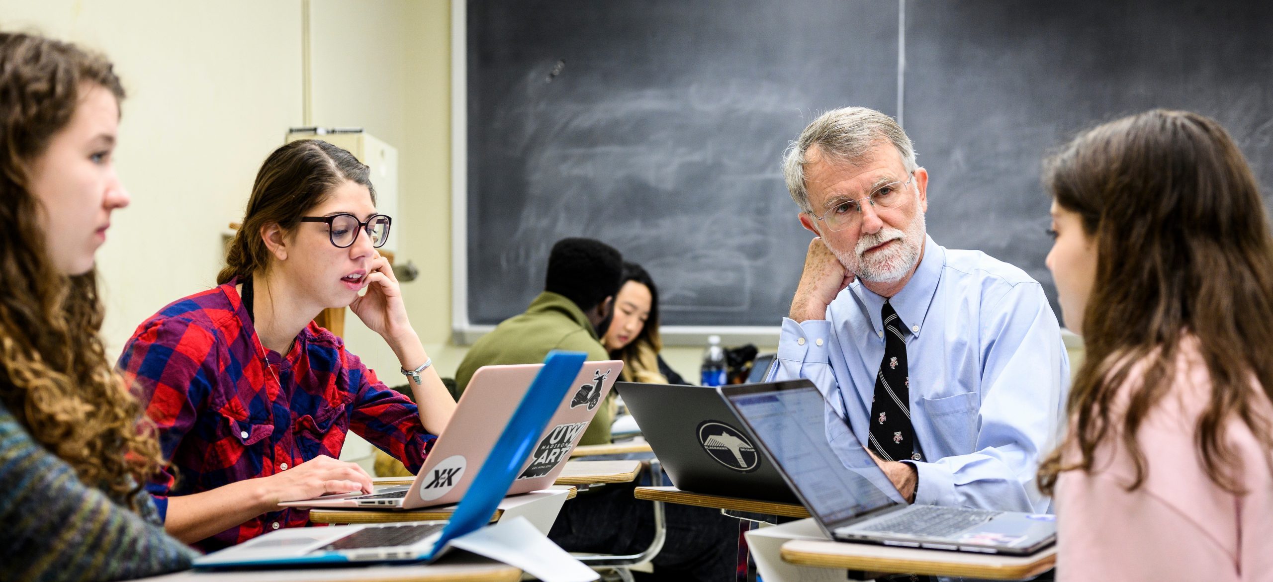 A participant speaks to a table of 3 other participants